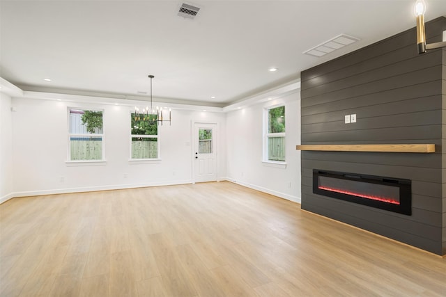882 Prosper St, Houston, TX 77088 - unfurnished living room featuring a glass covered fireplace, light wood-style floors, and recessed lighting