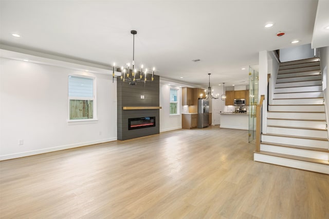 882 Prosper St, Houston, TX 77088 - unfurnished living room featuring a chandelier, stairs, light wood-type flooring, recessed lighting, and a fireplace