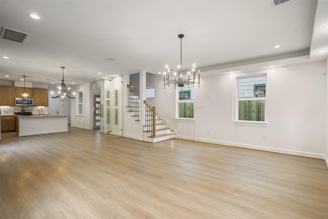 882 Prosper St, Houston, TX 77088 - unfurnished living room with a chandelier, recessed lighting, stairway, and light wood-style floors