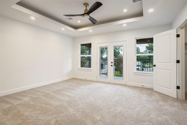 882 Prosper St, Houston, TX 77088 - carpeted empty room featuring a tray ceiling, ceiling fan, recessed lighting, and french doors
