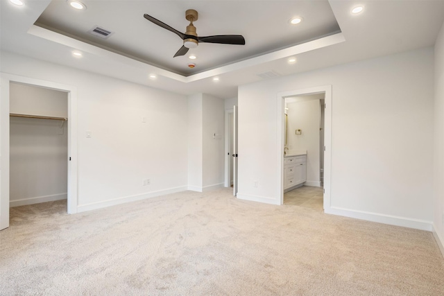 882 Prosper St, Houston, TX 77088 - unfurnished bedroom featuring a raised ceiling, recessed lighting, light carpet, a spacious closet, and ensuite bathroom