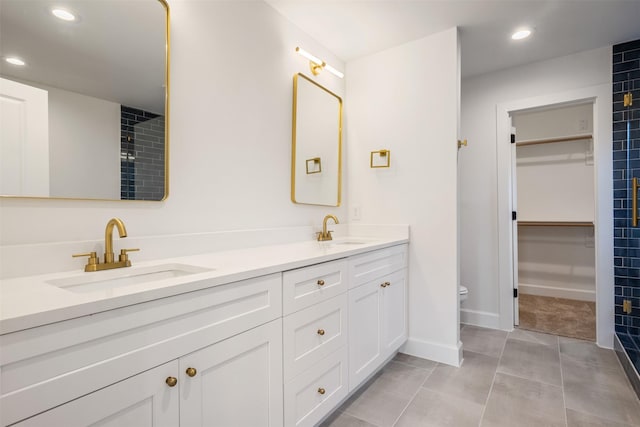 882 Prosper St, Houston, TX 77088 - full bathroom featuring double vanity, recessed lighting, a spacious closet, and tile patterned floors