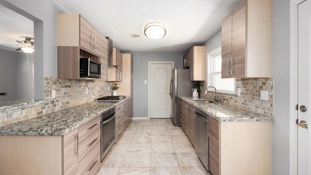 8106 Montridge Dr, Houston, TX 77055 - kitchen featuring appliances with stainless steel finishes, light marble finish floors, tasteful backsplash, light brown cabinets, and light stone countertops