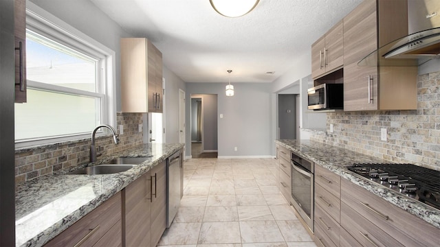 8106 Montridge Dr, Houston, TX 77055 - kitchen with stainless steel appliances, wall chimney range hood, backsplash, light stone counters, and light marble finish floors