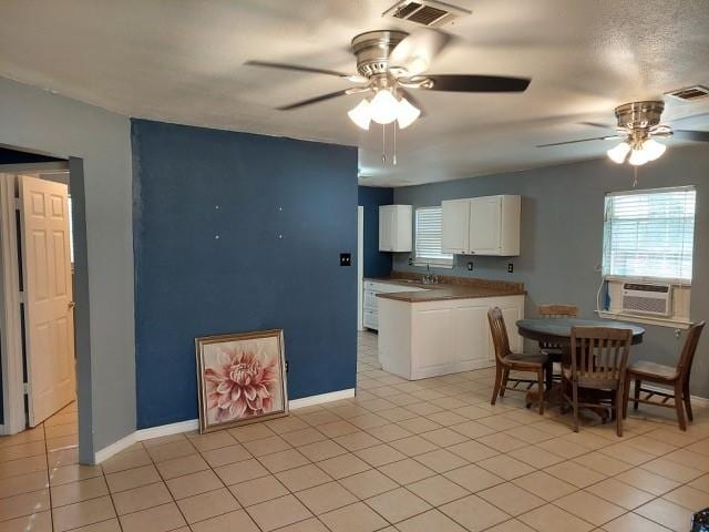 380 Rae Ann Blvd, Livingston, TX 77351 - kitchen with cooling unit, ceiling fan, white cabinets, and plenty of natural light