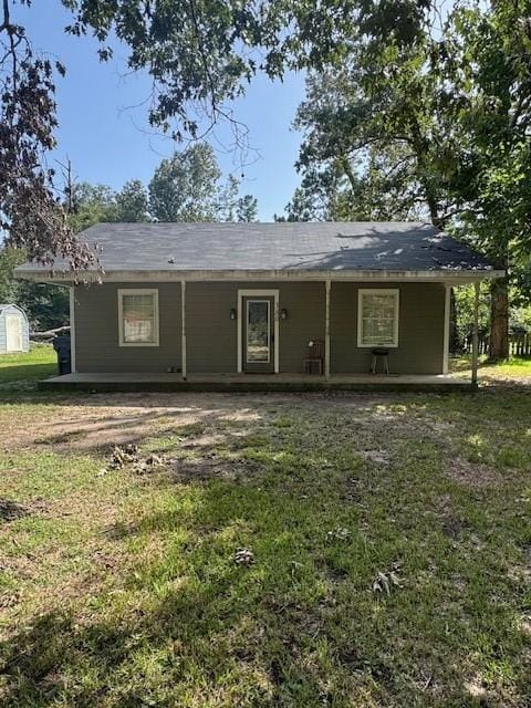 380 Rae Ann Blvd, Livingston, TX 77351 - back of house with a porch and a lawn