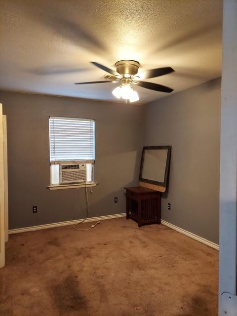 380 Rae Ann Blvd, Livingston, TX 77351 - unfurnished room with cooling unit, carpet flooring, ceiling fan, and a textured ceiling