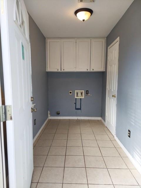 380 Rae Ann Blvd, Livingston, TX 77351 - washroom featuring light tile patterned flooring, hookup for a washing machine, cabinet space, and hookup for an electric dryer