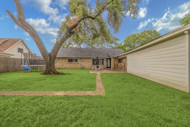 16217 Singapore Ln, Jersey Village, TX 77040 - fenced backyard featuring a patio and a trampoline