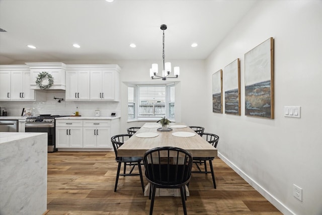 16217 Singapore Ln, Jersey Village, TX 77040 - dining space featuring a chandelier, wood finished floors, and recessed lighting