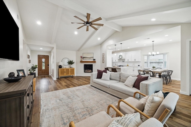 16217 Singapore Ln, Jersey Village, TX 77040 - living area featuring recessed lighting, beam ceiling, dark wood finished floors, a chandelier, and a ceiling fan