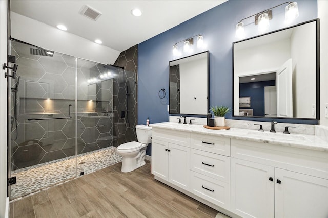 16217 Singapore Ln, Jersey Village, TX 77040 - bathroom featuring double vanity, a stall shower, wood finished floors, and recessed lighting
