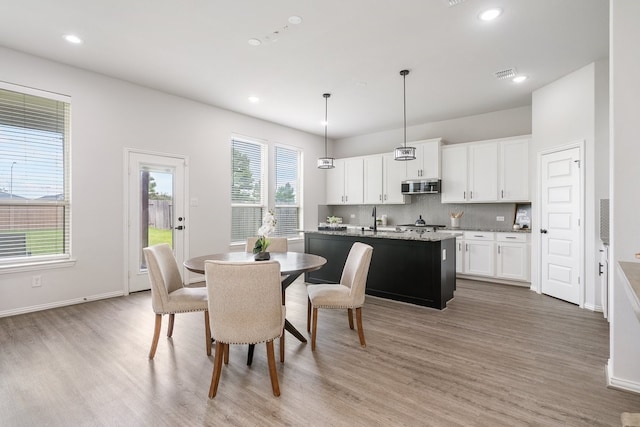 4118 Palmer Meadow Ct, Katy, TX 77494 - dining space featuring light wood finished floors and recessed lighting