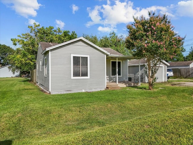 1312 22nd St N, Texas City, TX 77590 - back of property with a lawn and covered porch