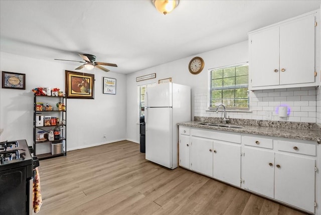 1312 22nd St N, Texas City, TX 77590 - kitchen with freestanding refrigerator, ceiling fan, decorative backsplash, and light wood finished floors