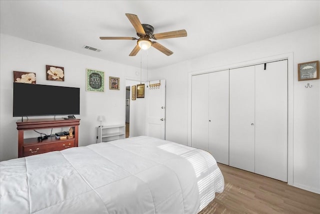 1312 22nd St N, Texas City, TX 77590 - bedroom featuring wood finished floors, a closet, and a ceiling fan