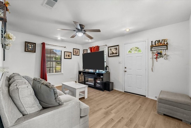 1312 22nd St N, Texas City, TX 77590 - living area with plenty of natural light, a ceiling fan, and light wood-style flooring