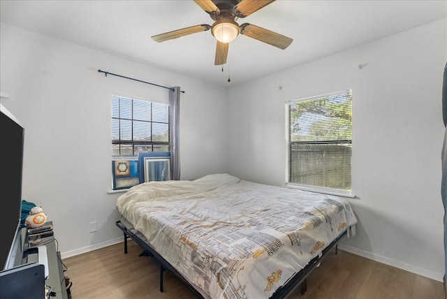 1312 22nd St N, Texas City, TX 77590 - bedroom featuring wood finished floors and a ceiling fan