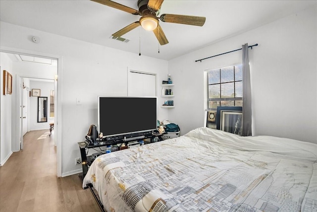 1312 22nd St N, Texas City, TX 77590 - bedroom featuring attic access, wood finished floors, and ceiling fan