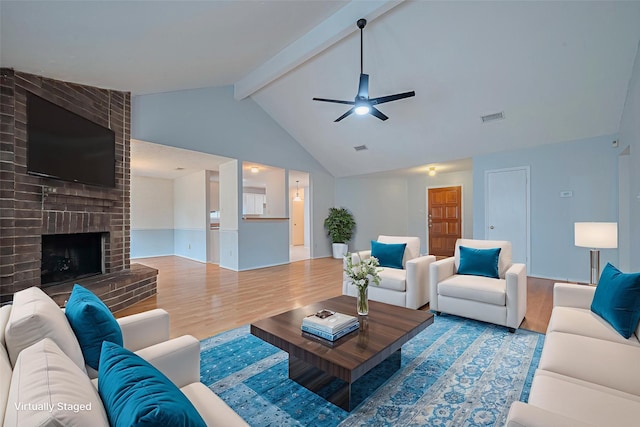 22522 Round Valley Dr, Katy, TX 77450 - living area with wood finished floors, beamed ceiling, a ceiling fan, a fireplace, and high vaulted ceiling