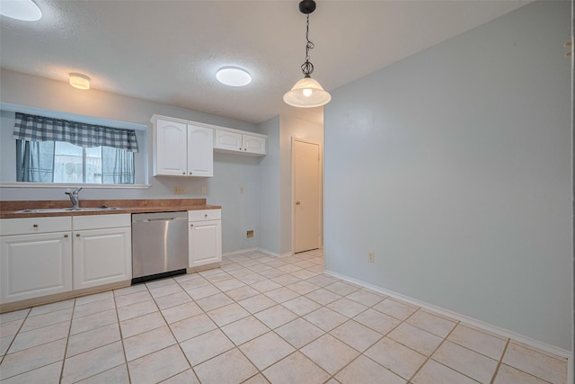 22522 Round Valley Dr, Katy, TX 77450 - kitchen with stainless steel dishwasher, pendant lighting, white cabinets, a textured ceiling, and light tile patterned floors