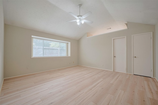 22522 Round Valley Dr, Katy, TX 77450 - unfurnished bedroom with vaulted ceiling, light wood finished floors, a textured ceiling, and ceiling fan