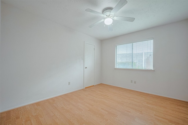 22522 Round Valley Dr, Katy, TX 77450 - empty room featuring light wood-style floors, ceiling fan, and a textured ceiling