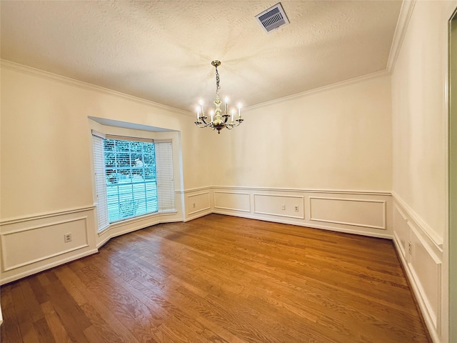 2147 Heather Green Dr, Houston, TX 77062 - empty room with a chandelier, crown molding, a decorative wall, wood finished floors, and a textured ceiling