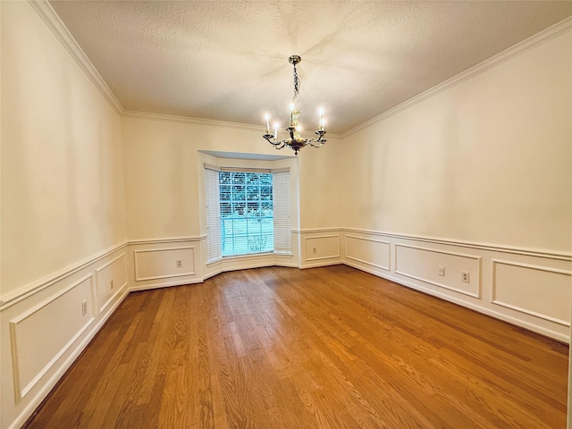 2147 Heather Green Dr, Houston, TX 77062 - unfurnished room featuring a chandelier, ornamental molding, a decorative wall, wood finished floors, and wainscoting