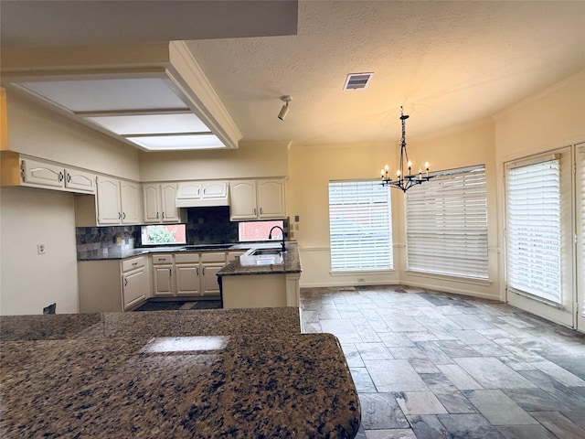 2147 Heather Green Dr, Houston, TX 77062 - kitchen featuring a chandelier, stone tile floors, tasteful backsplash, dark stone counters, and black electric cooktop