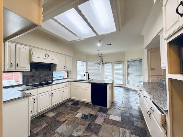 2147 Heather Green Dr, Houston, TX 77062 - kitchen with black appliances, a peninsula, stone tile flooring, tasteful backsplash, and white cabinets