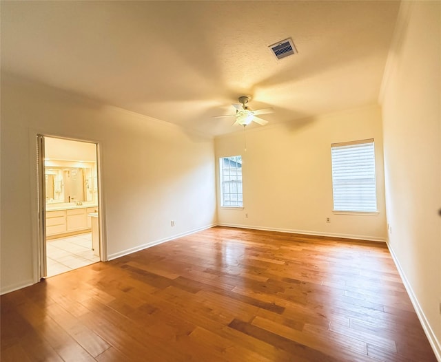 2147 Heather Green Dr, Houston, TX 77062 - spare room featuring ceiling fan, light wood-type flooring, and ornamental molding