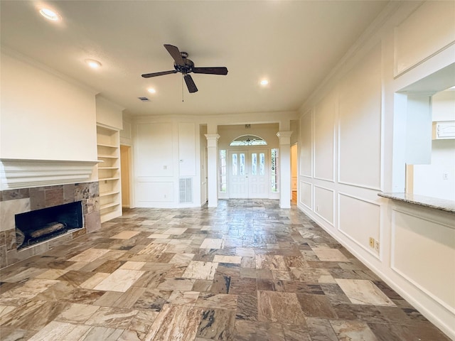 2147 Heather Green Dr, Houston, TX 77062 - unfurnished living room with ceiling fan, built in shelves, ornate columns, a fireplace, and recessed lighting