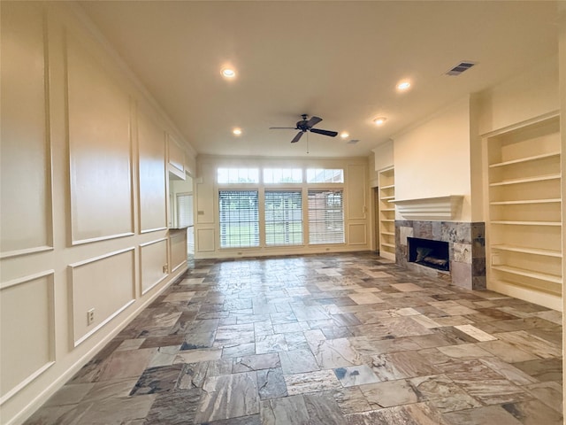2147 Heather Green Dr, Houston, TX 77062 - unfurnished living room with built in shelves, a ceiling fan, a premium fireplace, recessed lighting, and a decorative wall