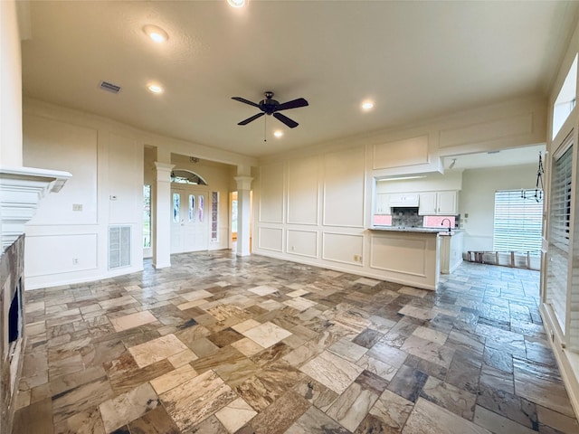 2147 Heather Green Dr, Houston, TX 77062 - unfurnished living room with a decorative wall, stone tile flooring, a fireplace, a ceiling fan, and recessed lighting