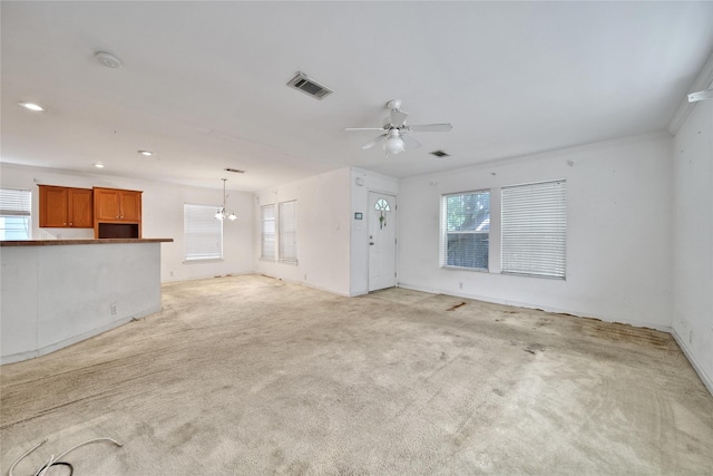 11307 Normeadow Ln, Houston, TX 77076 - unfurnished living room with ceiling fan, light carpet, recessed lighting, and a chandelier