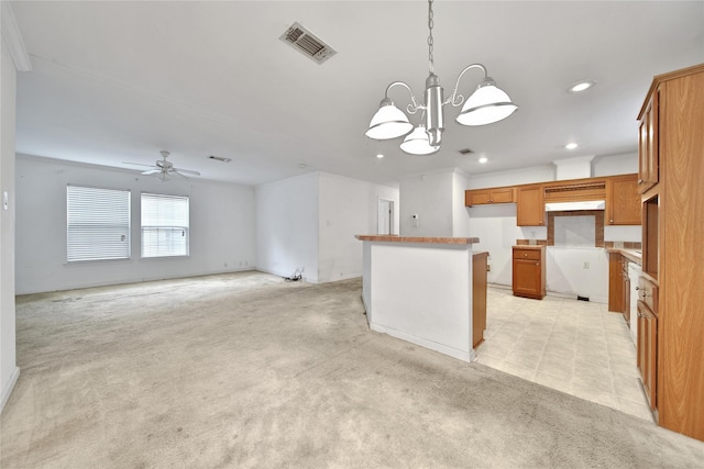 11307 Normeadow Ln, Houston, TX 77076 - kitchen featuring recessed lighting, brown cabinetry, light carpet, a chandelier, and a ceiling fan