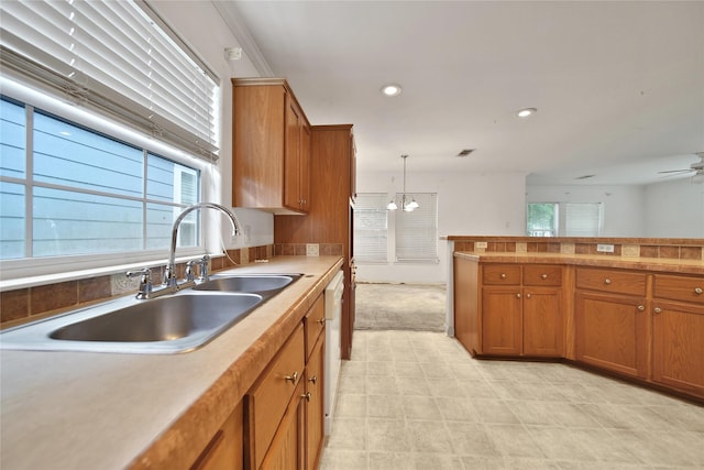11307 Normeadow Ln, Houston, TX 77076 - kitchen featuring brown cabinets, a chandelier, ceiling fan, light countertops, and recessed lighting