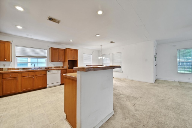 11307 Normeadow Ln, Houston, TX 77076 - kitchen with dishwasher, brown cabinetry, recessed lighting, a chandelier, and a center island