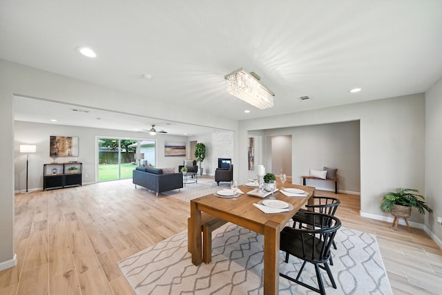 4003 Mischire Dr, Houston, TX 77025 - dining space featuring light wood-type flooring, recessed lighting, a ceiling fan, and a chandelier