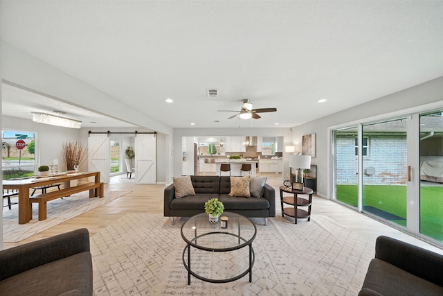 4003 Mischire Dr, Houston, TX 77025 - living area with a barn door, recessed lighting, healthy amount of natural light, ceiling fan, and light wood-style flooring