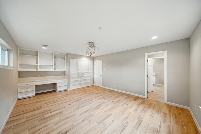 4003 Mischire Dr, Houston, TX 77025 - unfurnished bedroom featuring built in study area, light wood finished floors, and recessed lighting