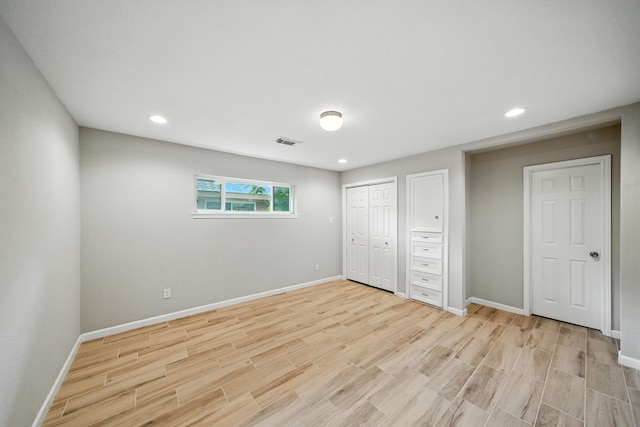 4003 Mischire Dr, Houston, TX 77025 - unfurnished bedroom featuring light wood-style floors and recessed lighting