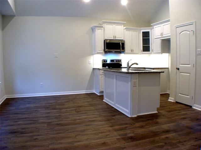 16725 Stonefield, Montgomery, TX 77316 - kitchen with stainless steel appliances, white cabinetry, dark wood-type flooring, vaulted ceiling, and a center island with sink