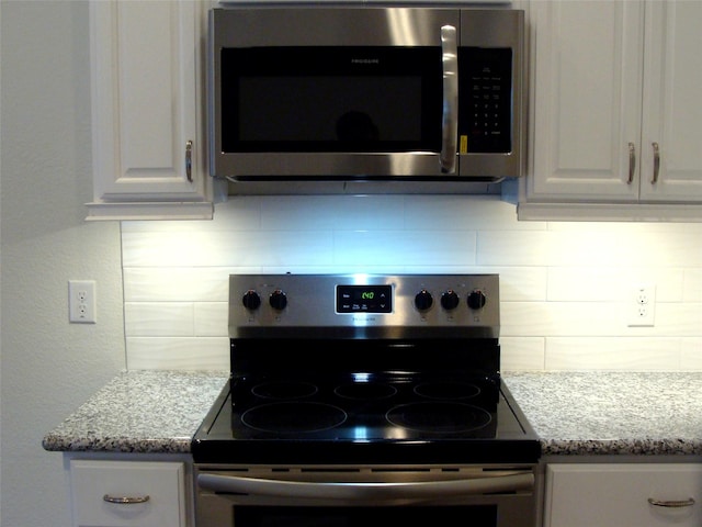 16725 Stonefield, Montgomery, TX 77316 - kitchen view of appliances with stainless steel finishes, tasteful backsplash, white cabinetry, and light stone countertops