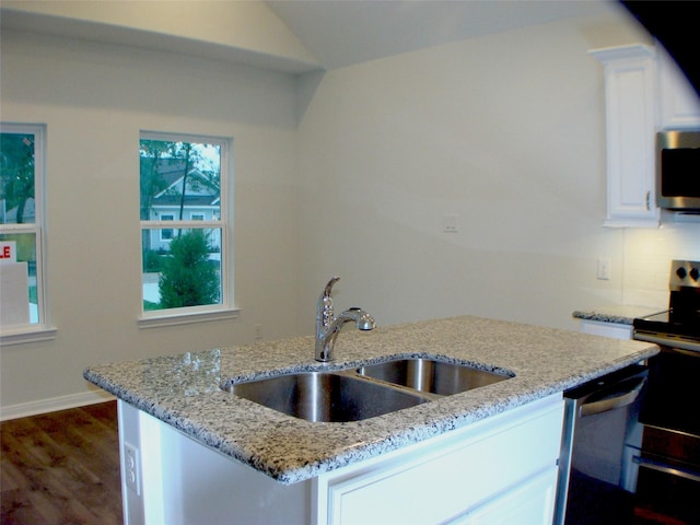 16725 Stonefield, Montgomery, TX 77316 - kitchen featuring appliances with stainless steel finishes, white cabinetry, light stone counters, dark wood-style flooring, and lofted ceiling