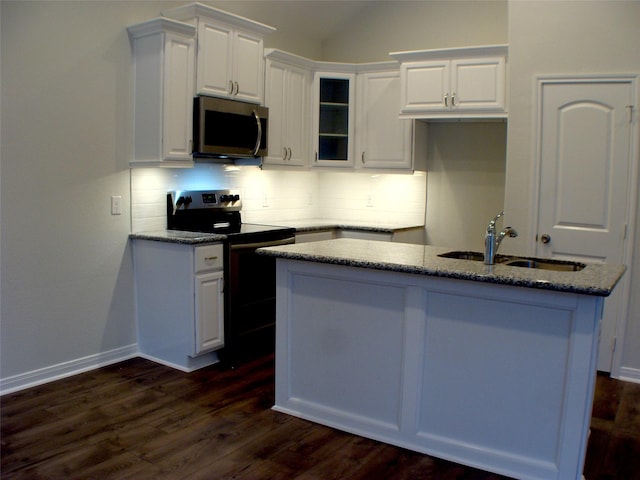 16725 Stonefield, Montgomery, TX 77316 - kitchen featuring electric range oven, stainless steel microwave, white cabinetry, stone countertops, and vaulted ceiling