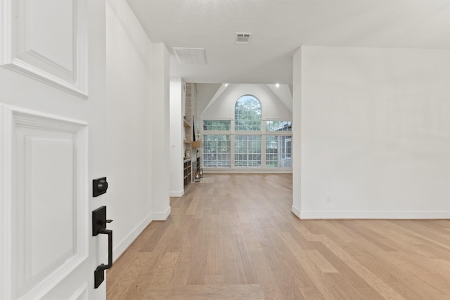 11 Forge Hill Pl, The Woodlands, TX 77381 - hallway with lofted ceiling and light wood-style flooring