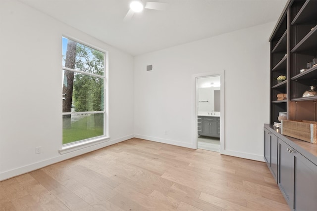 11 Forge Hill Pl, The Woodlands, TX 77381 - unfurnished room featuring a ceiling fan and light wood finished floors