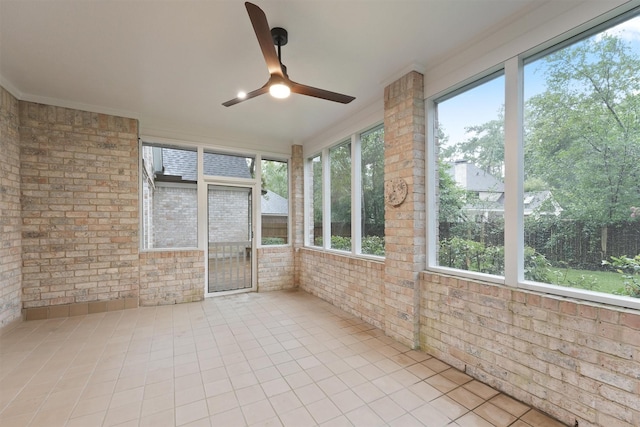 11 Forge Hill Pl, The Woodlands, TX 77381 - unfurnished sunroom with a ceiling fan, brick wall, and tile patterned flooring
